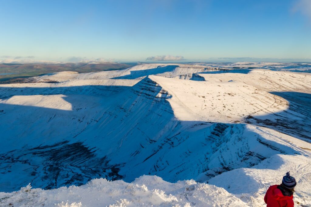 lady Hiking in the snow in the Cambrian Mountains in January.
